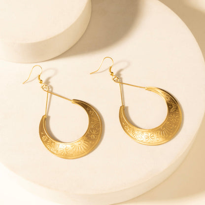 Gold-tone crescent drop earrings with engraved rim design and fishhook backs