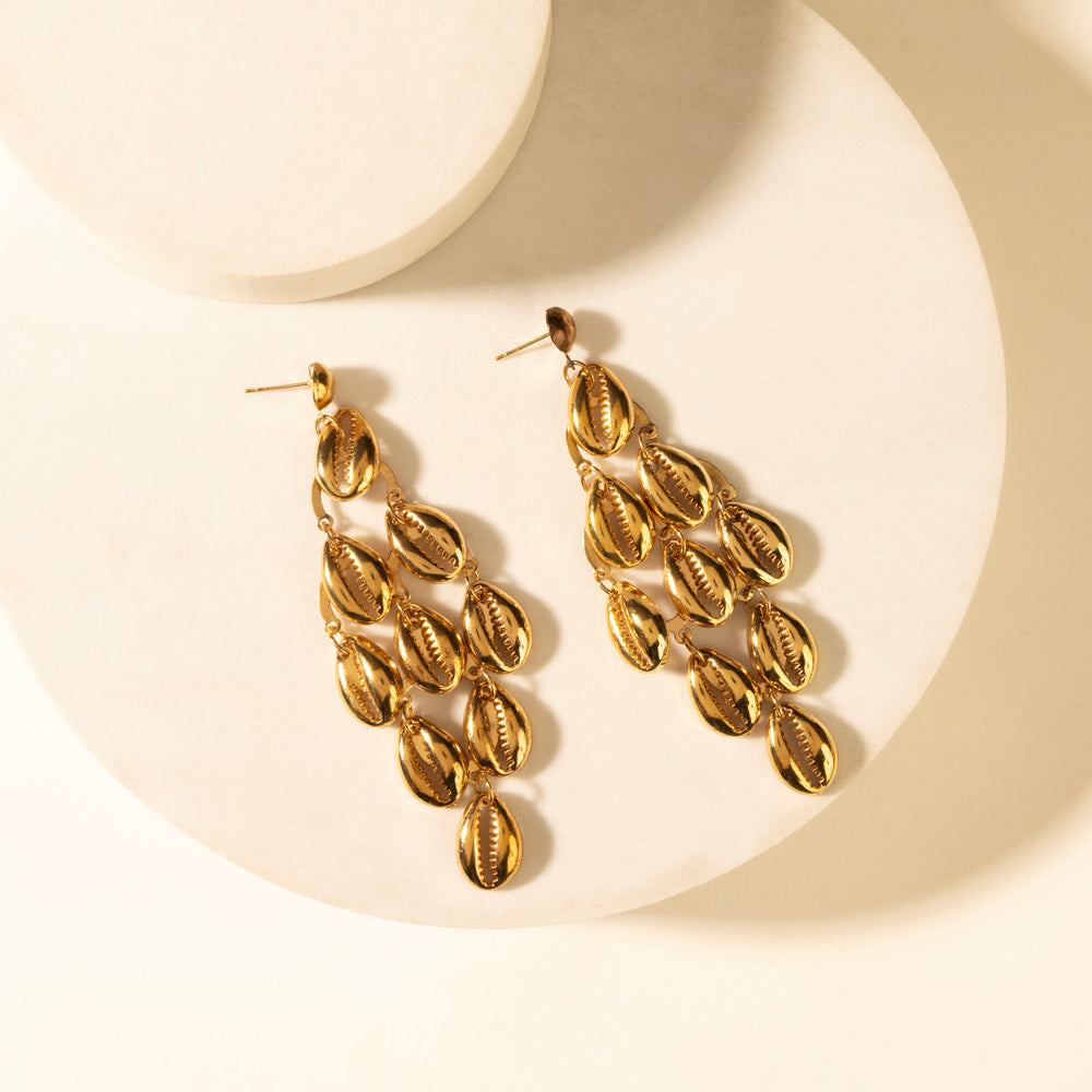 Gold shell-style dangling earrings with layered leaf charms