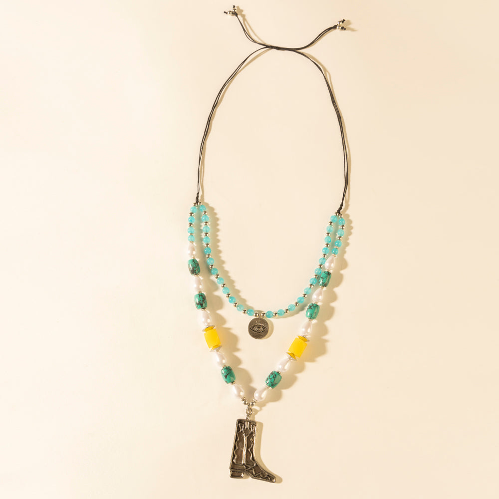 Layered turquoise bead necklace with cowboy boot pendant and coin charm