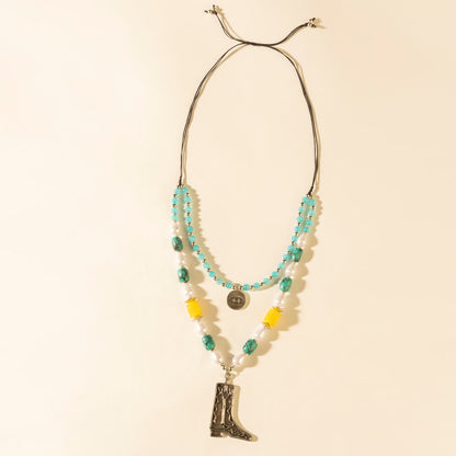 Layered turquoise bead necklace with cowboy boot pendant and coin charm