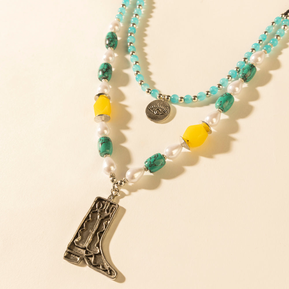 Layered turquoise bead necklace with cowboy boot pendant, pearl accents, coin charm