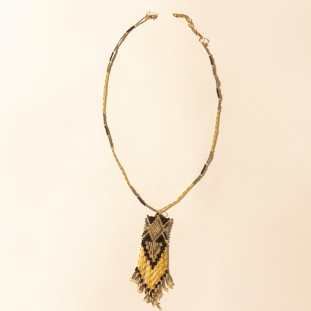 Beaded necklace with dark brown and gold crescent pendant and fringe