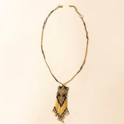 Beaded necklace with dark brown and gold crescent pendant and fringe