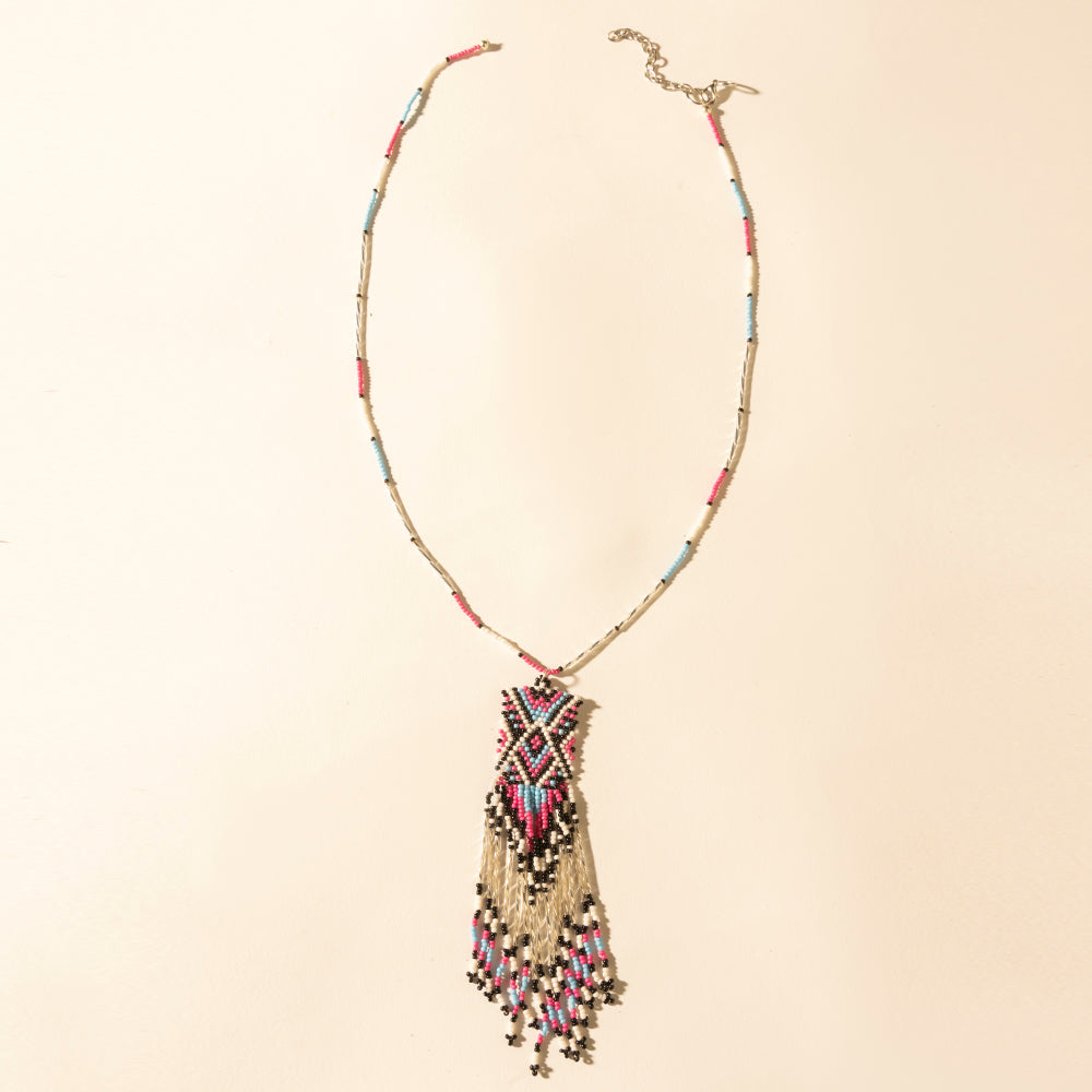 Beaded turquoise necklace with coral tassel pendant and gold-tone clasp