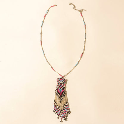 Beaded turquoise necklace with coral tassel pendant and gold-tone clasp