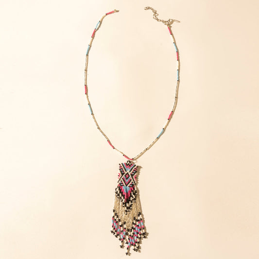 Beaded turquoise necklace with coral tassel pendant and gold-tone clasp