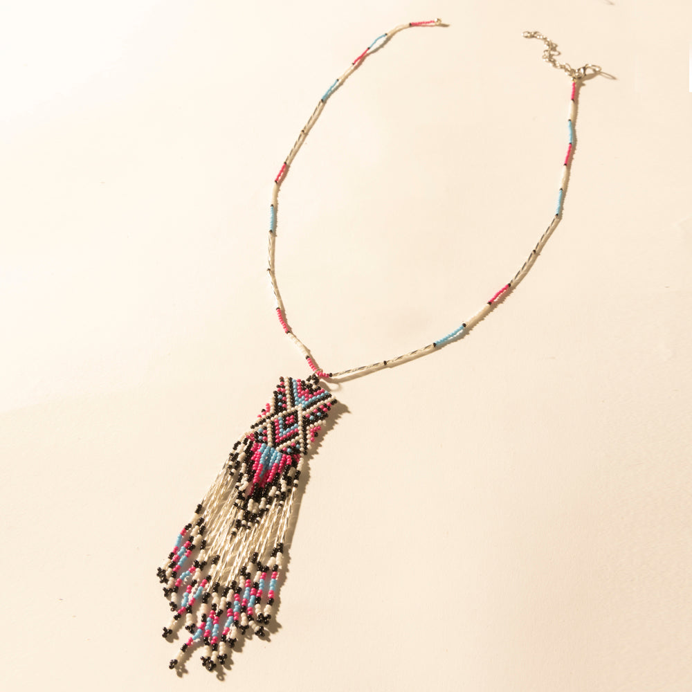 Beaded turquoise necklace with geometric pendant and coral fringe tassel