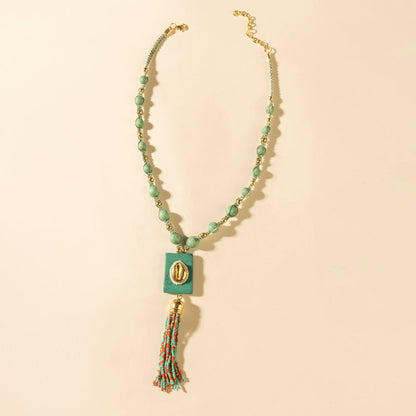 Myra Sun beaded necklace with turquoise beads, square pendant, and tassel charm