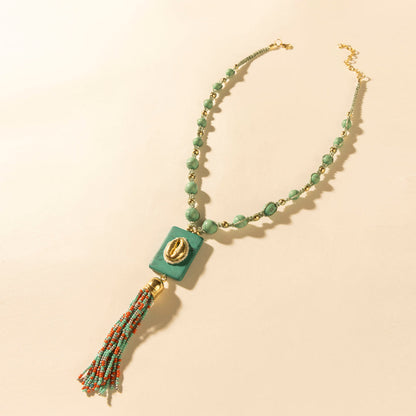 Myra Sun beaded necklace with turquoise beads, teal square pendant, and gold accent