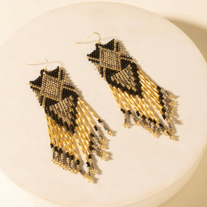 Pair of champagne beaded fringe earrings with black geometric tops and dangling beads