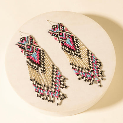 Beaded drop earrings with ivory fringe and multicolor bead patterns, dangling design