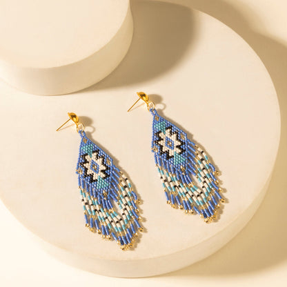 Beaded teardrop fringe earrings in cobalt blue with geometric motif, gold hooks