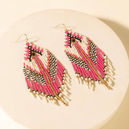 Pair of chevron bead earrings with pink and white stripes, black accents, gold drops