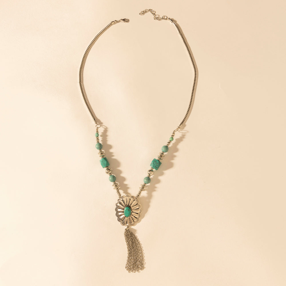 Tassel pendant necklace with silver chain and turquoise green bead accents