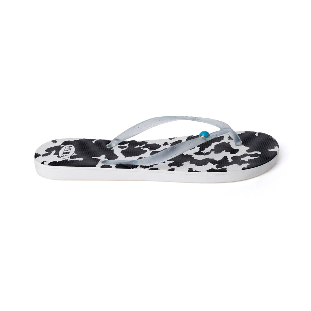 Cowhide slippers with black-and-white cow print straps and white sole
