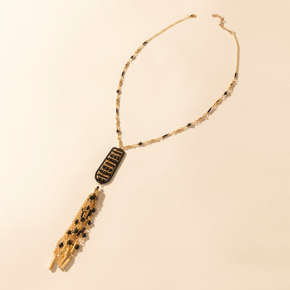 Burnished tan pendant necklace with black-gold rectangle pendant and fringe tassel