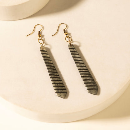 Striped drop earrings with gold-tone hooks; long dark gray bar dangles with lines