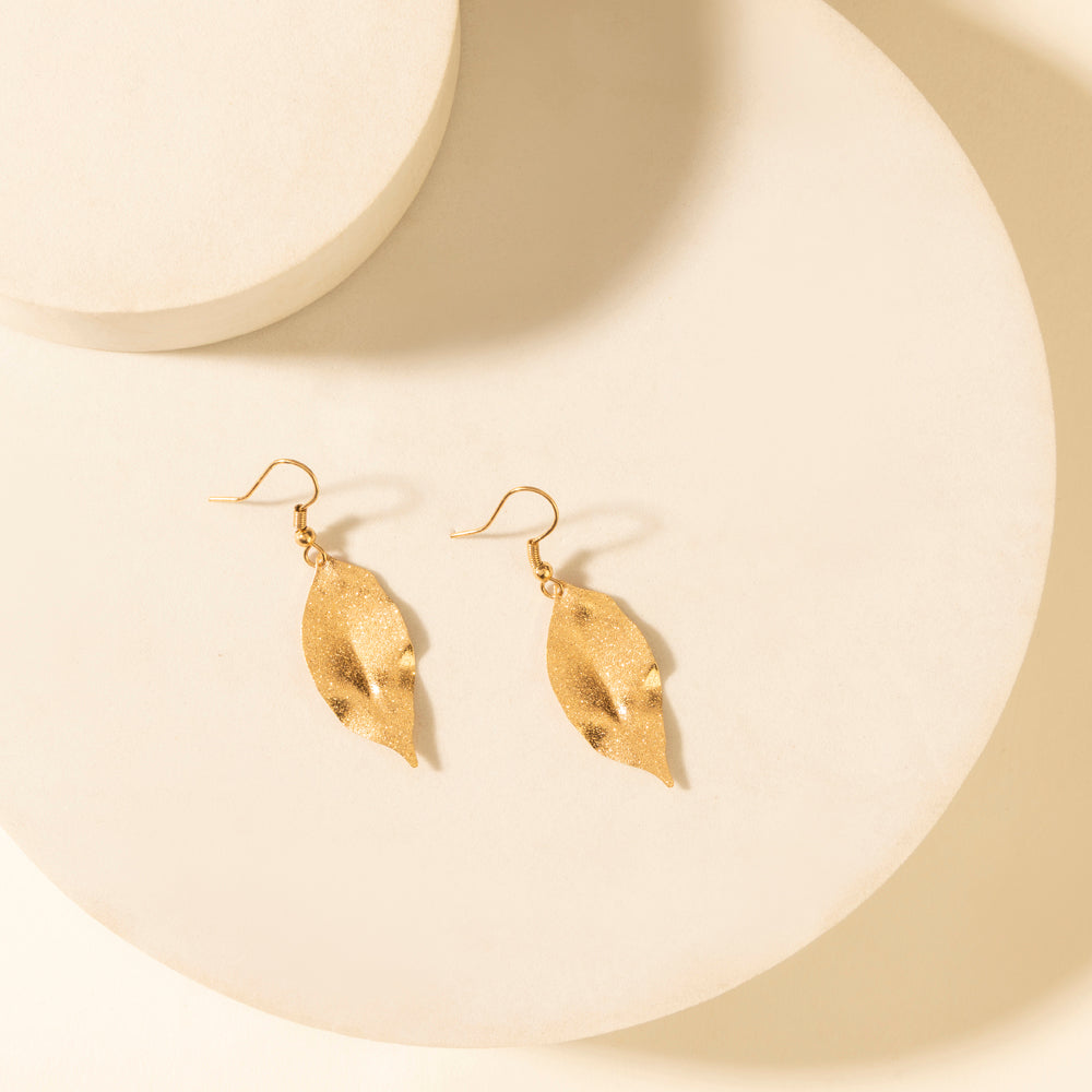 Leaf-shaped dangle earrings in weathered amber with gold-tone hooks