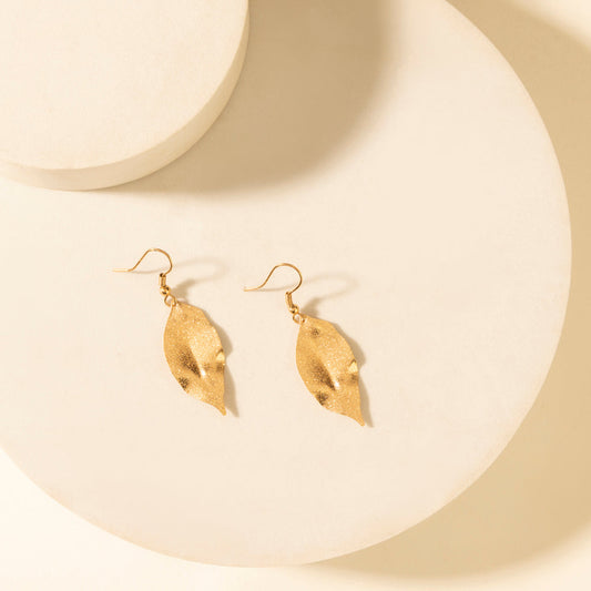 Leaf-shaped dangle earrings in weathered amber with gold-tone hooks