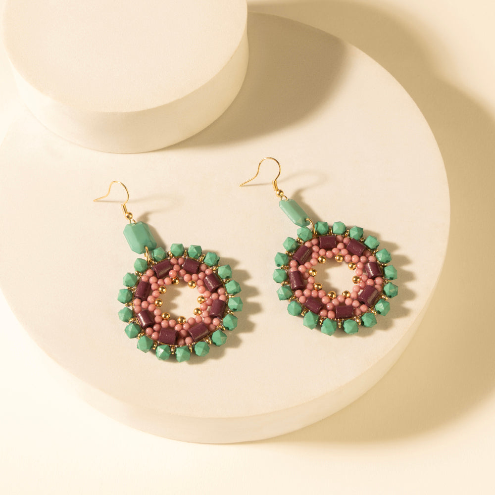 Beaded medallion drop earrings in green and pink with turquoise plum outer beads