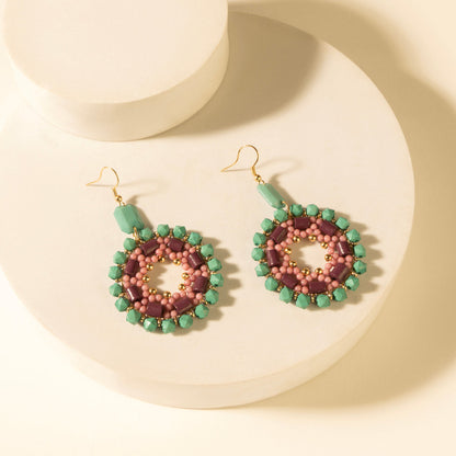 Beaded medallion drop earrings in green and pink with turquoise plum outer beads