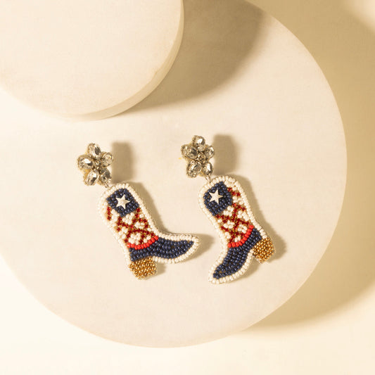 Boot-shaped beaded earrings with star and red, white, blue patchwork, gold accents.