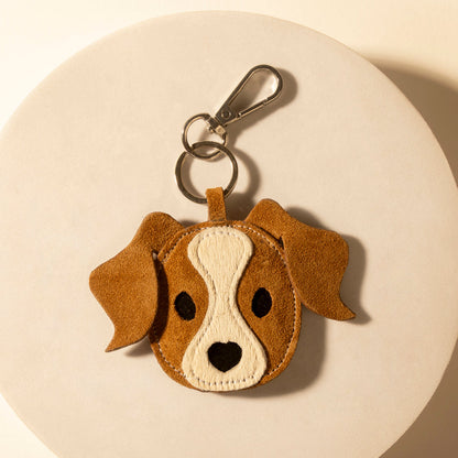 Pup charm keychain in tan suede, stitched dog face with metal clip and ring.