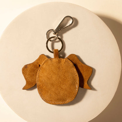 Pup charm keychain in tan suede, round dog body with metal clip and ring.