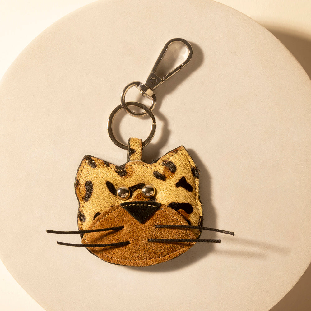 Leopard-print cat keychain with metal clip; tan with brown spots and whiskers