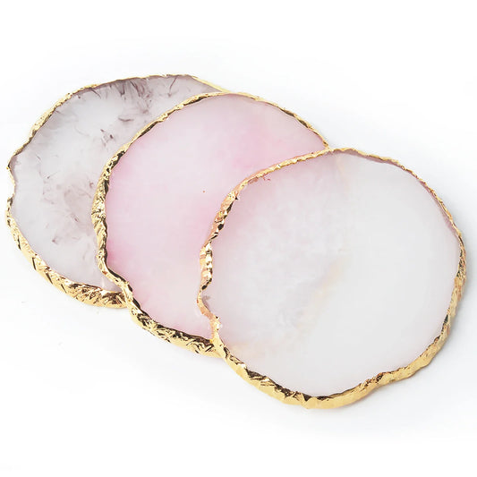 Round resin agate nail art palette trays in pink, white, and gray tones with gold edge.
