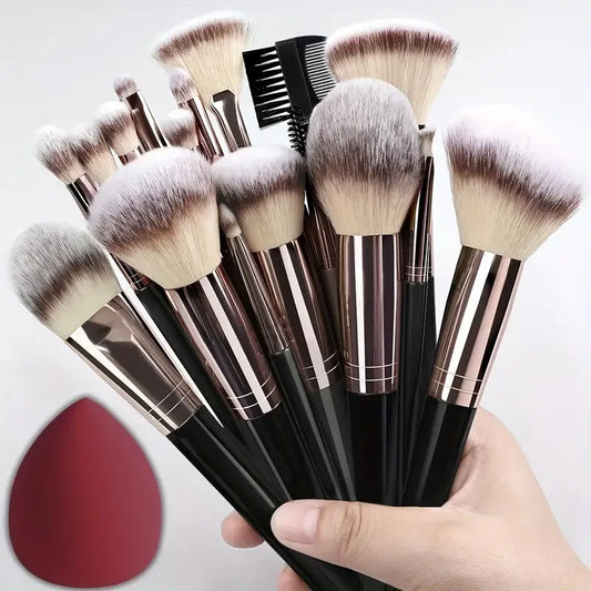 Makeup brush set with black handles and silver ferrules, soft fluffy bristles, in hand