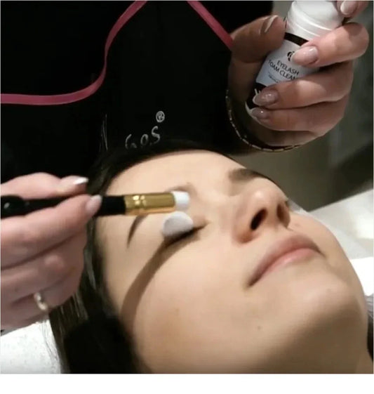 Eyelash cleaning brush using foam on lashes, with gold cap and white tip