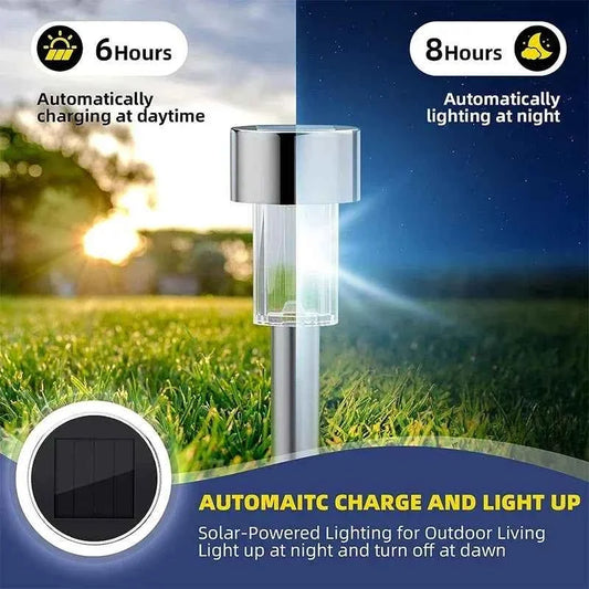 Solar stake lantern light with stainless cap and clear top, glowing white outdoors