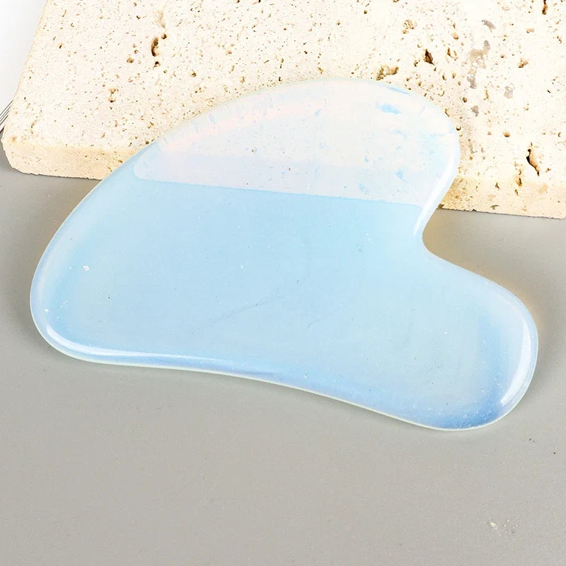 Facial gua sha stone tool, light blue translucent heart shape