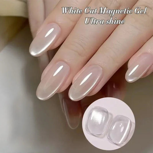 White cat eye magnetic gel nail polish on glossy pale pink nails