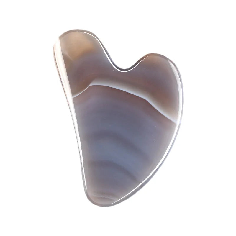 Facial gua sha stone massager, dark marbled purple-brown surface with curved edge
