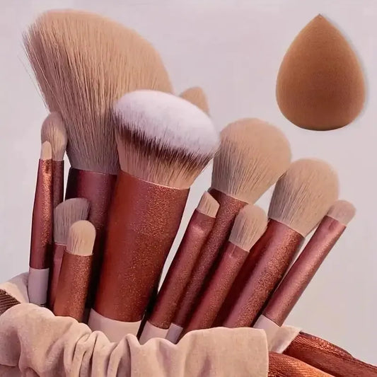 Makeup brush set with rose-gold handles and fluffy beige bristles, with storage bag