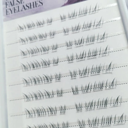 Close-up of wispy false eyelash clusters on a tray, shown in multiple rows