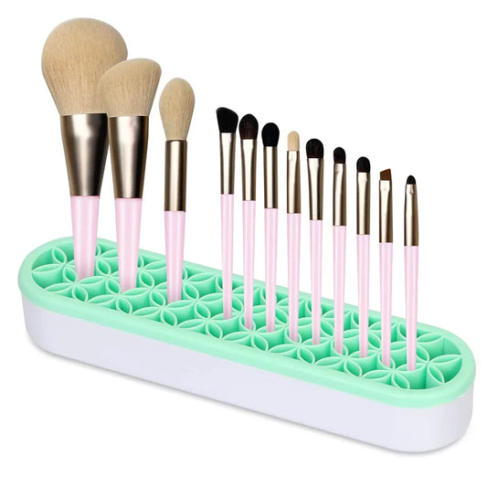 Green nail brush drying rack with star-pattern silicone slots, holding makeup brushes