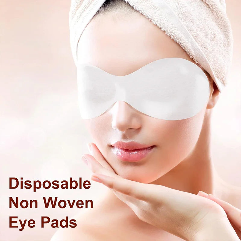 Disposable white eye pads pair on a person’s face, nonwoven skincare style