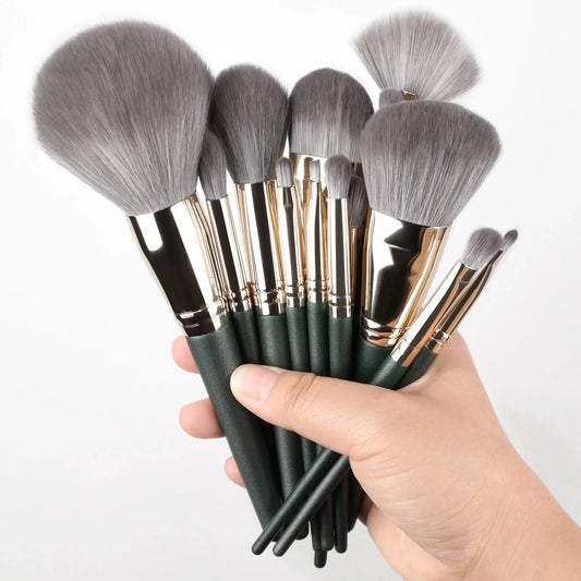 Green-handled makeup brush set with soft gray bristles for face and eye makeup