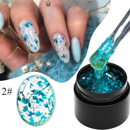 Blue gel nail polish with teal dried flower patterns on nails and gel bottle labeled 2