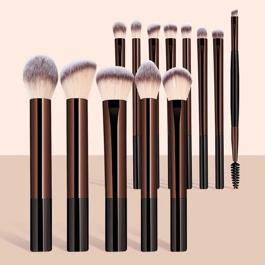 Makeup brush set with black and gold handles, fluffy fan-shaped face brushes.