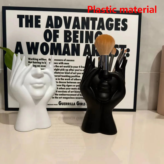 White and black human-face makeup brush holders with bundled makeup brush bristles