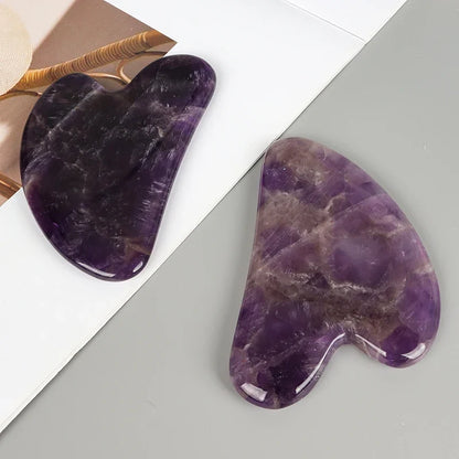 Facial gua sha stone tools, purple crystal heart shapes with natural swirls