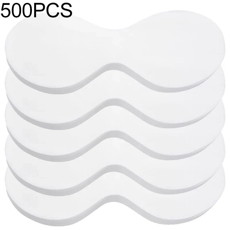 Stack of 500 disposable white eye pads, curved under-eye shape