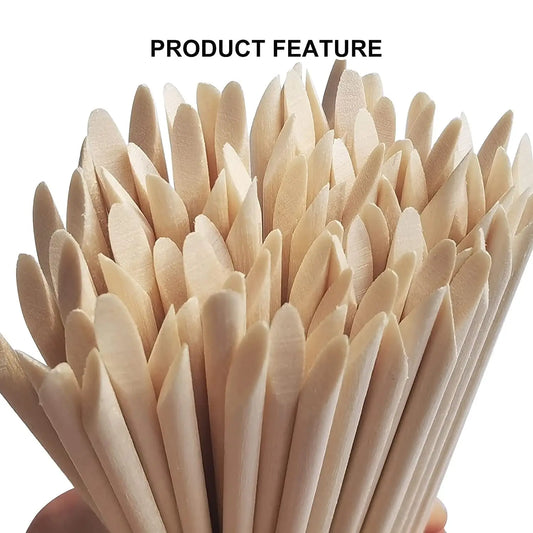 Bundle of pale tan pointed wooden nail sticks for cuticle pushing and dotting
