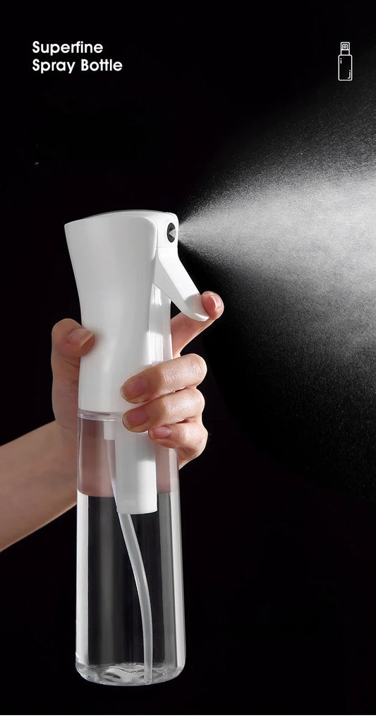 Refillable white mist spray bottle with trigger handle and clear refill tank, hand-held