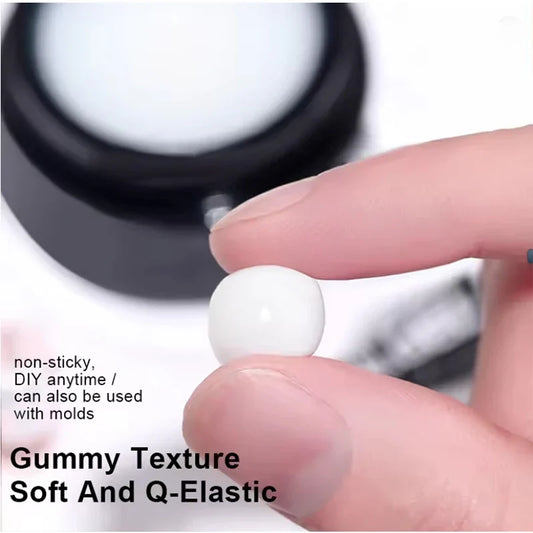 White soft nail extension gel scoop shown on a finger from a black jar