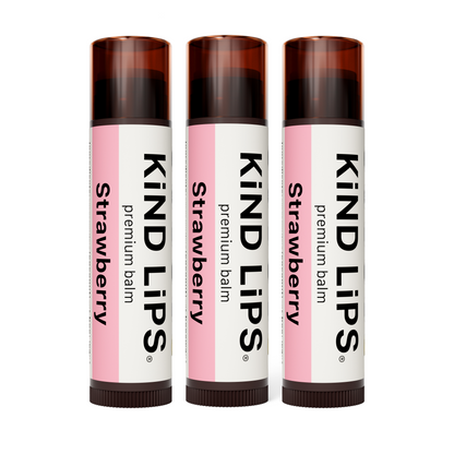 Set of three strawberry lip balms in white-and-pink tubes with brown caps